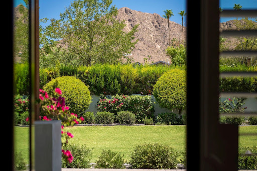 Buy this luxury property in Phoenix (United States) - Landscaped garden with green lawn and shrubs