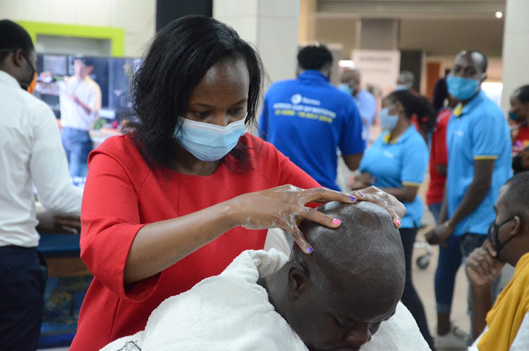 Beberia Cuts Plantinum masseuse gives a head massage to a father after the hair cut.