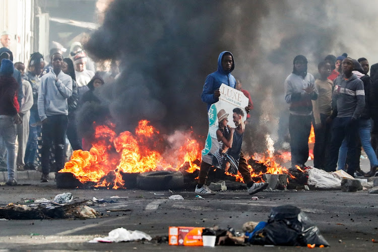 Residents of Masiphumelele in Cape Town set up burning barricades during a strike by taxi operators on August 8 2023.