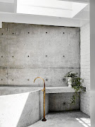 A  concrete wet room - floors, walls, bath and side table - by Damian Oliveri was added to the original bathroom and is one of the couple's favourite rooms.