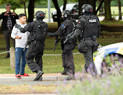 AOS (Armed Offenders Squad) push back members of the public following a shooting at the Masjid Al Noor mosque in Christchurch, New Zealand,, March 15, 2019.