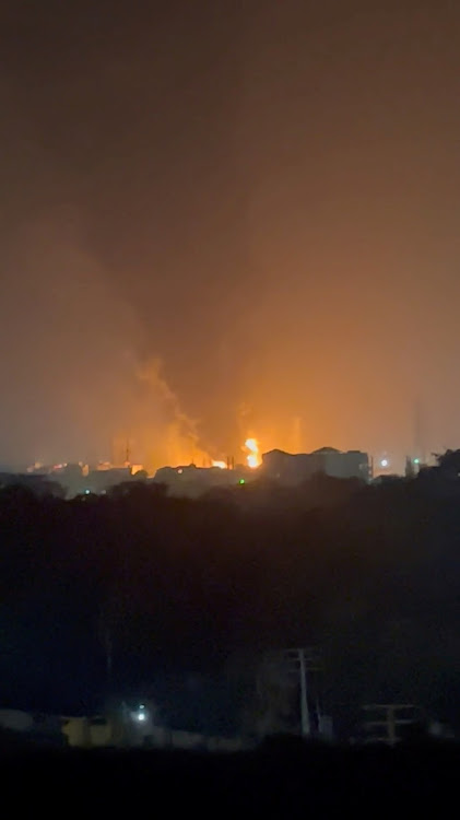 Flames and smoke rise, following a blast at an oil terminal, in Conakry, Guinea, early on Monday, in this screen grab taken from social media video. Image: Mohamed Fikri Fawaz/via REUTERS