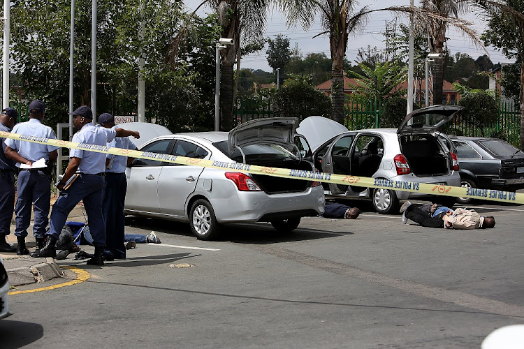 Five robbery suspects lie on the ground at the BP garage on Corlett Drive, outside the upmarket Melrose Arch lifestyle centre, on March 27 2019.