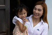 Panompai Sithong holds her 3-year-old daugther Paveenut Supolwong, nicknamed Ammy, who is the only child survivor of the day care centre mass shooting, during a family meeting at their home in Uthai Sawan, Nong Bua Lam Phu province, Thailand, October 9, 2022.