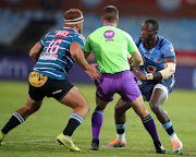 Madosh Tambwe of the Bulls is challenged by Janco Uys of the Griquas during their Carling Currie Cup match at Loftus Versfeld Stadium in Pretoria on Saturday.