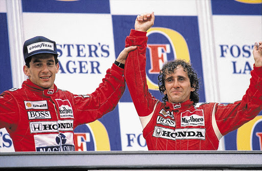 DRIVEN TO ENMITY: Alain Prost, right, celebrates a win over team-mate Ayrton Senna. Their rivalry ended their friendship Picture: