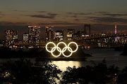 The Olympic Rings installed on a floating platform with the Rainbow Bridge in the background in preparation for the Tokyo 2020 Olympic Games in Tokyo. 