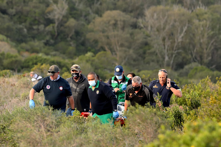 A search party scours the Baakens Valley where Kathleen Flanagan, 34, was found on the footpath of a hikers' trail.