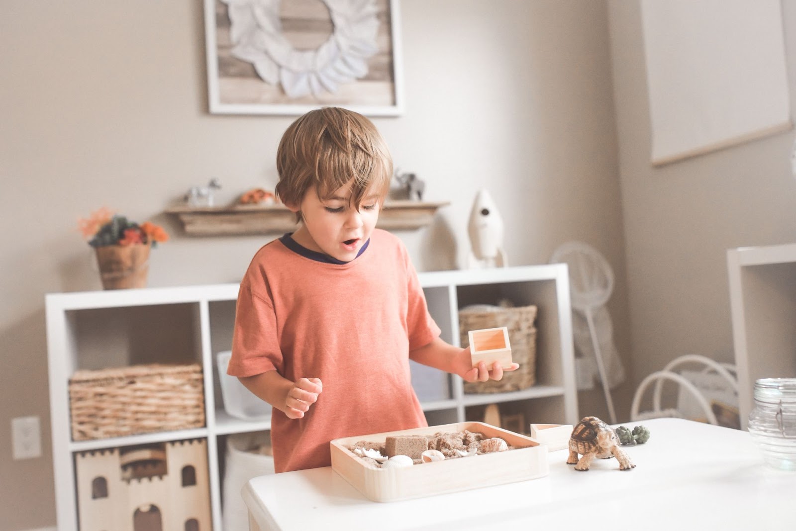 Toddler playing sensory play in a montessori environment