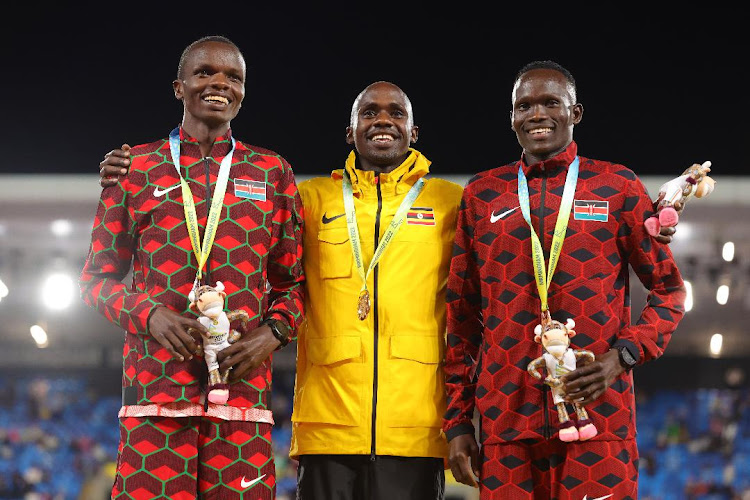 Uganda's Jacob Kiplimo in the middle alongside sillver medallist Daniel Simiu and bronze medallist Kibiwott Kandie