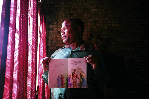 Gelozi Munyeni, a San of Platfontein, Northern Cape, with a book written in his language