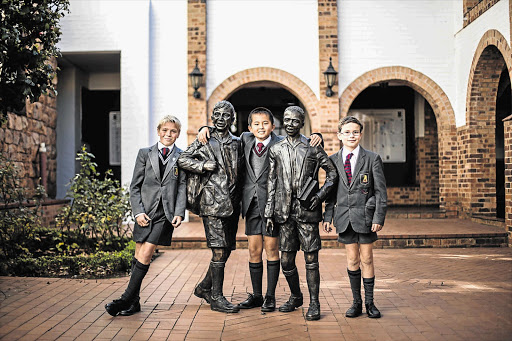 LITERARY LADS: From left, Sean Morrison, 13, Andi Qu, 11, and Justin West, 12, at the St John's Preparatory School in Johannesburg. The trio will be joined by Max Milella to compete at the international Kids Literary Quiz in England on July 8 See Page 8