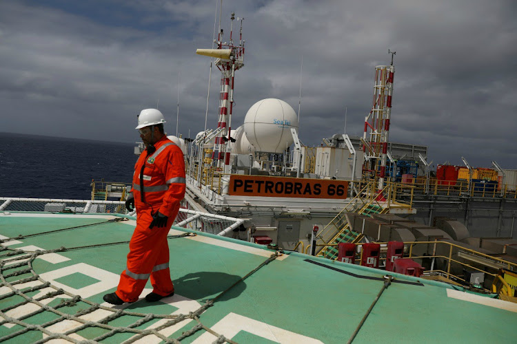 A worker walks on the heliport at the Brazil's Petrobras P-66 oil rig in the offshore Santos basin in Rio de Janeiro on September 5 2018.