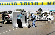 SEARCHING FOR CLUES: Forensics experts inspect the scene of a cash-in-transit heist at OR Tambo International Airport. Three men were injured during the attack