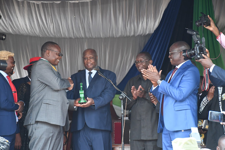 Busia's second governor, Otuoma, receives the county seal from his predecessor Sospeter Ojaamong.