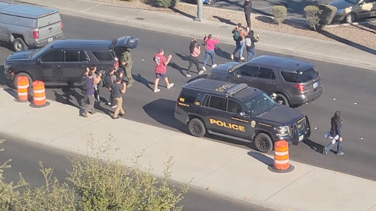 People leave campus with raised hands following reports of a shooting at the University of Nevada, in the campus of Las Vegas, US, in this screengrab taken from a handout video.