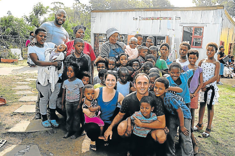 Joshua and Rachel Minter with some of the caregivers and children from the creche in Stoney Drift that they started a few years ago.