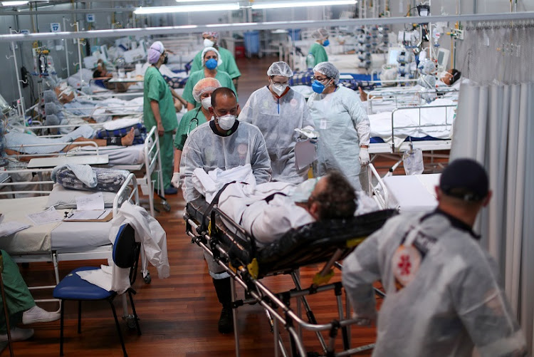 A patient suffering from the coronavirus disease (Covid-19) is transported at a field hospital set up at Dell'Antonia sports gym in Santo Andre, on the outskirts of Sao Paulo, Brazil April 7, 2021.