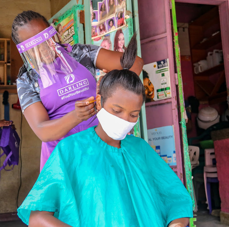 Gladyce Muthoni plaits Laura Ganza's hair