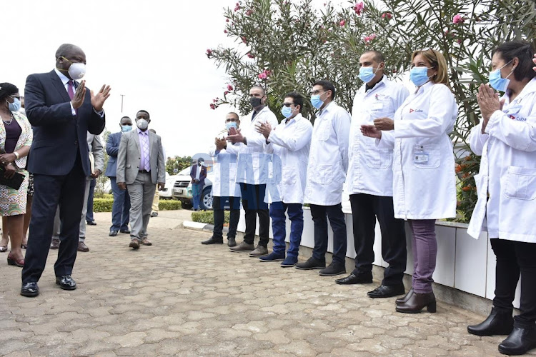 Health CS Mutahi Kagwe welcomes the new set of Cuban doctors who recently came to the country to help in the fight against the coronavirus pandemic during the launch of ICU and HDU beds at Kenyatta University Teaching Referal and Research hospital on August 5,2020.