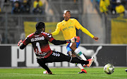 Thapelo Morena of Mamelodi Sundowns is challenged by Wolfrigon Ngobo of AS Otoho during last weekend's CAF match where Morena picked up a groin strain. 