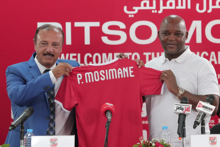 Mohsen Saleh, head of the football planning committee at Al Ahly, presents new coach Pitso Mosimane to the media in a press conference in Cairo on Saturday.