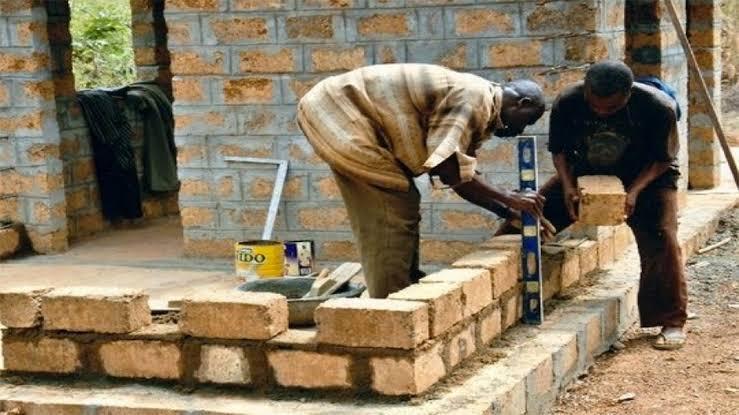 Job creation - Two few men building a wall