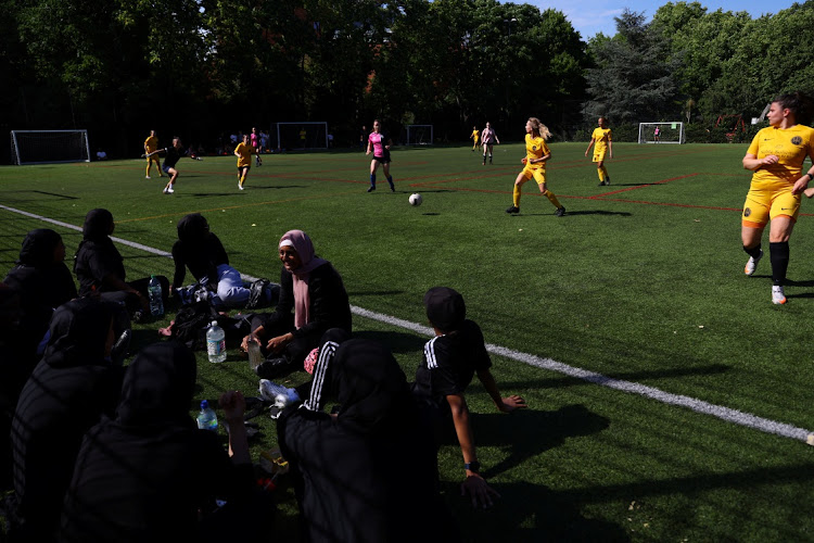 Sisterhood Football Club team members rest on the side of the pitch while they wait for their next Ladies Super Liga 7-a-side tournament match, at Archbishop’s Park football pitch in London, Britain, on July 24 2022. Picture: REUTERS/HANNAH MCKAY