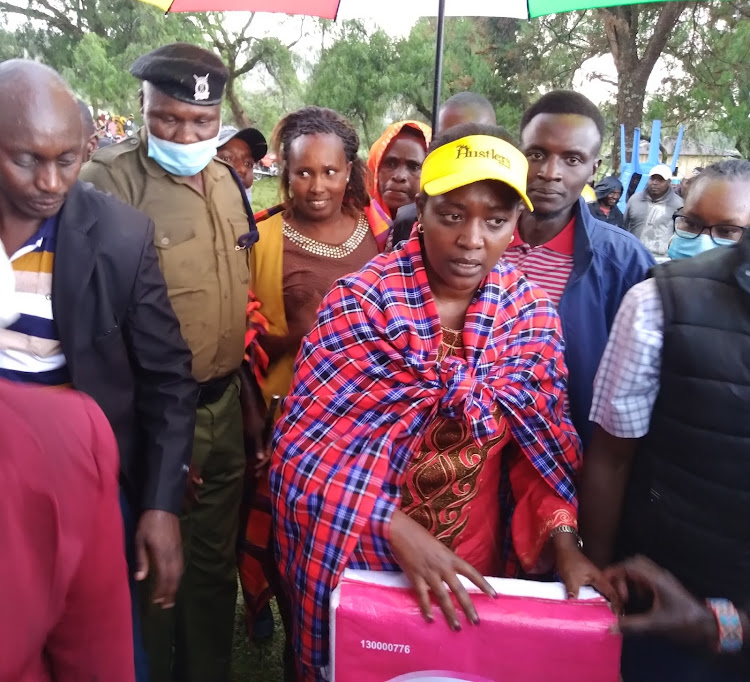 Narok Woman Representative Soipan Kudate distributes sanitary towels and water tanks in Ilmotiok ward in Narok West subcounty.