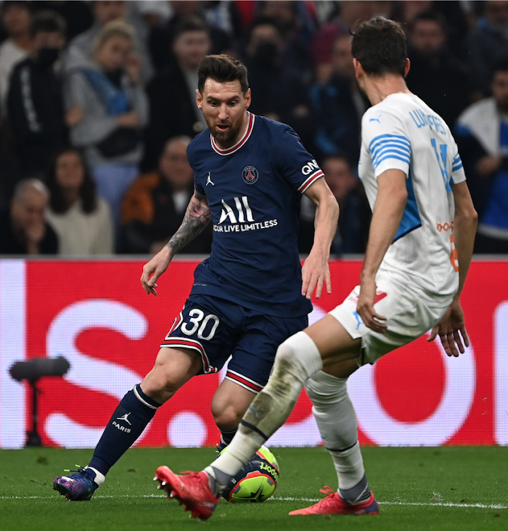 Paris Saint-Germain's Argentinian forward Lionel Messi in action with Marseille's Luan Peres during a French L1 match at Stade Velodrome in Marseille October 24