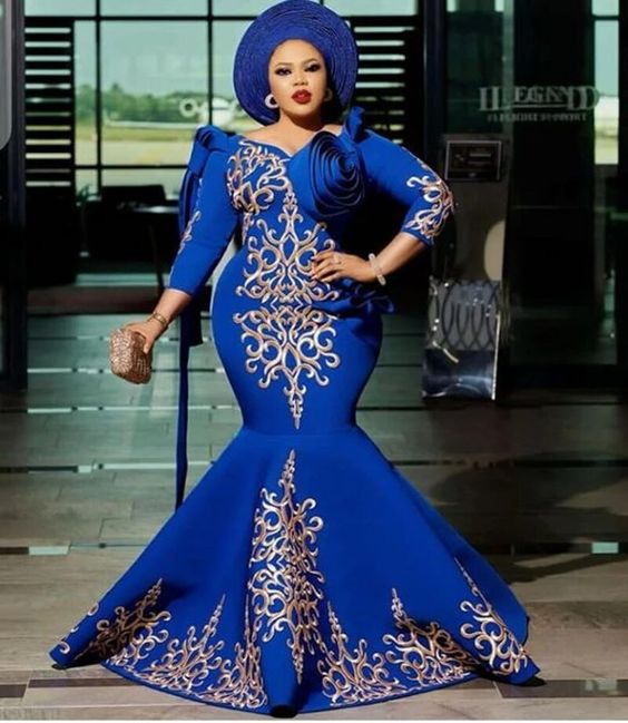 lady wearing blue gele with matching mermaid dress