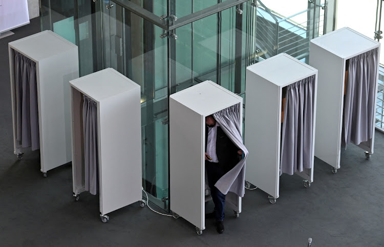 A voter leaves a voting booth during the assembly of the Federal Convention at the Paul-Loebe-Haus parliamentary building, as the Federal Assembly gathers to elect the new German President in Berlin.