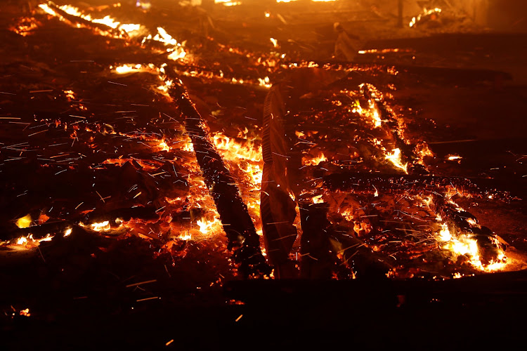 Wind-driven ambers are seen during the Camp Fire in Paradise, California, US November 8, 2018.