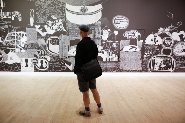 A visitor looks at Kemang Wa Lehulere's 'The Grave Step' at the 8th Berlin Biennale for Contemporary Art in 2014.