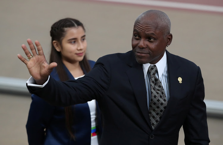 Carl Lewis waves during a past championship