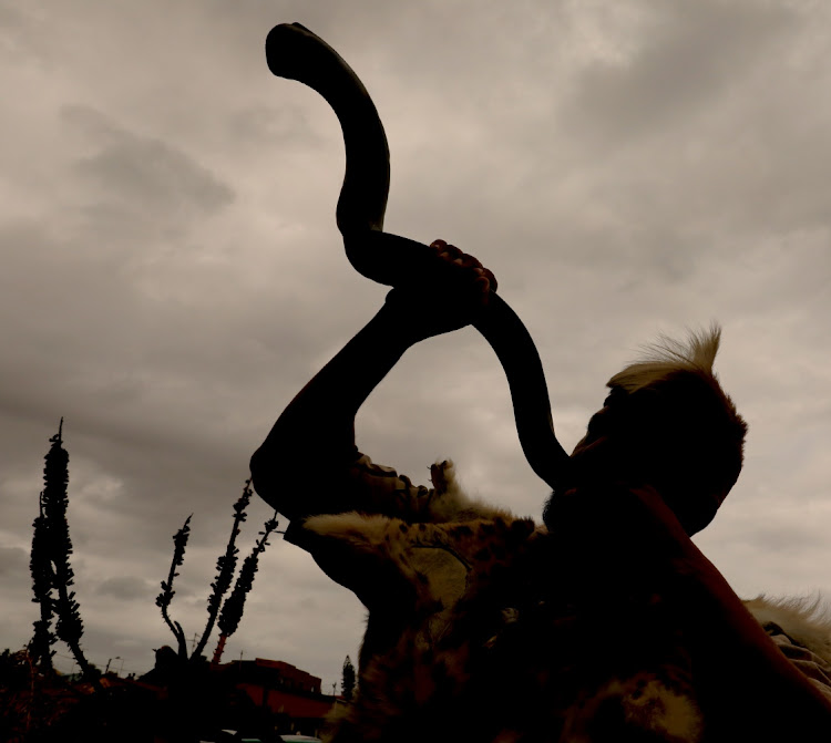 An attendee blows on a kudu horn at the inauguration of Khoisan Chief Gert Steenkamp. The writer says the tribe should have been the first people to resist occupation of this country by colonialists.