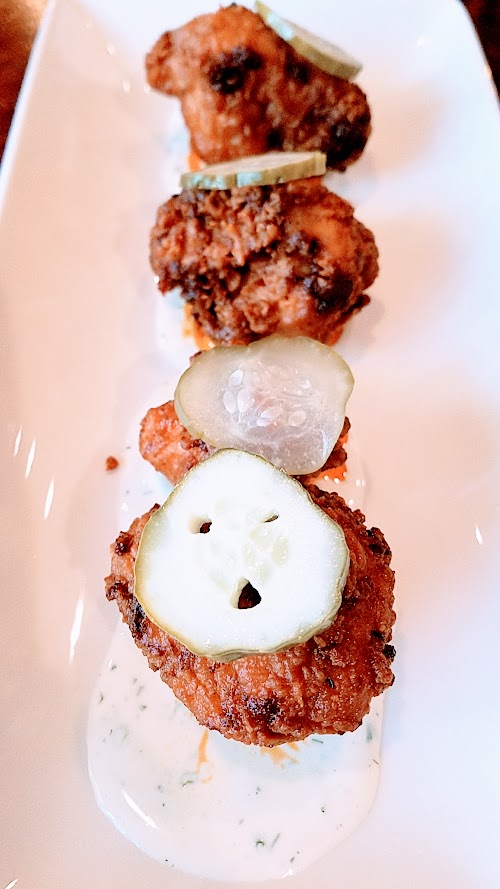 Superbite Happy Hour item of Nashville Hot Fried Cauliflower plate with cucumber ranch, grandma agnes pickles