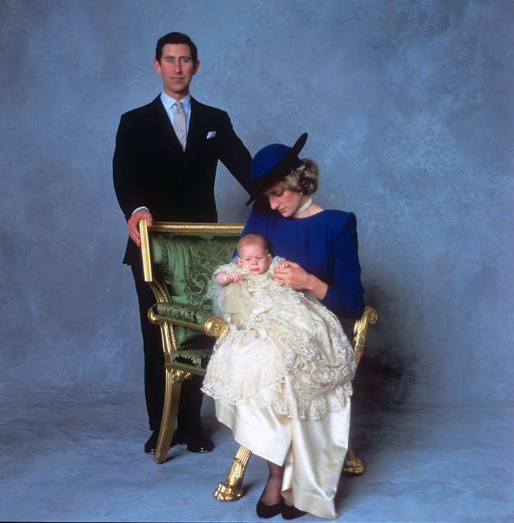 Three-month-old Prince Harry in the original vintage Honiton christening gown, pictured with his parents, the Prince and Princess of Wales.