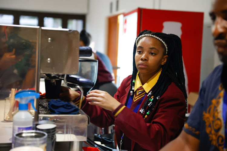 15-year-old Boitumelo Eland from Emshukantambo Secondary School in Pimville, Soweto, on a training program to become a barista working for Huis Van Cofifi coffee shop.