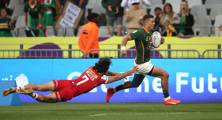 Muller du Plessis of the Blitzboks evades the tackle of Canada's Brock Webster during Day 1 of the 2022 HSBC Cape Town Sevens at Cape Town Stadium in Cape Town on 09 November 2022.