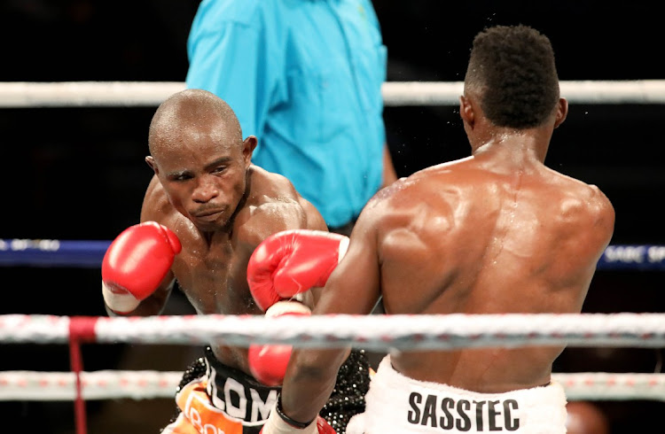 Prince Dlomo lands a punch Xolani Ndongeni during Jnr Welterweight at Klipspruit Sports Centre,Soweto.