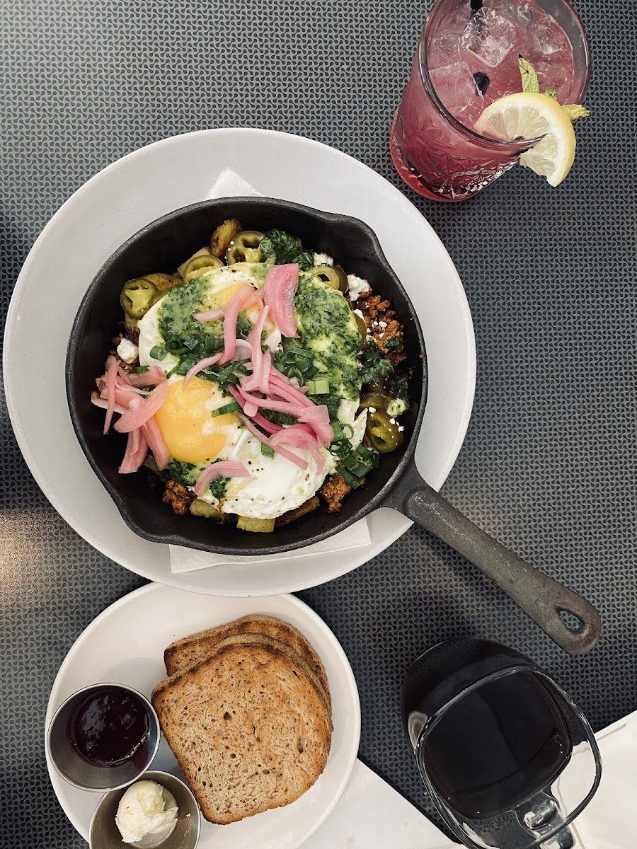 Brunch! Pictured is the spicy hash, GF toast, and the Blueberry Smash cocktail.