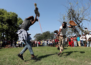 A man dodges a blow from a rival.  