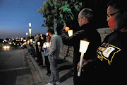 Campaigners light candles during a night vigil organised to oppose the passing of the Protection of State Information Bill outside the Constitutional Court in Johannesburg.