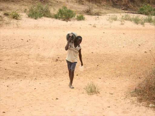 A boy returns from fetching water during a severe in Ukambani. /FILE