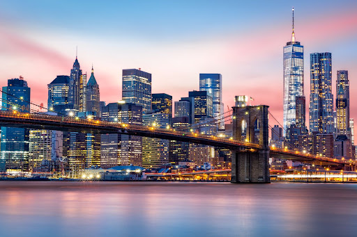 Brooklyn Bridge at and the Lower Manhattan skyline during sunset.