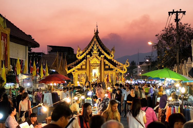 A bustling evening market in Chiang Mai, Thailand.