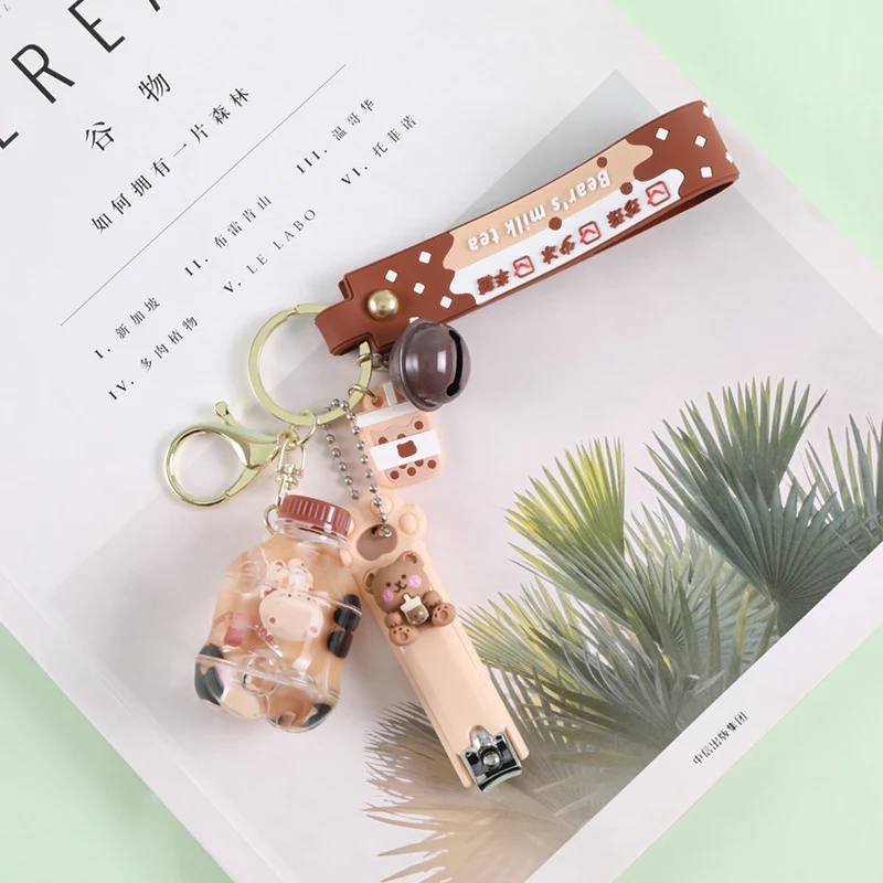 Porte-clés tasse de thé au lait en cristal, corde en cuir, boule de cheveux de dessin animé. Un accessoire mignon et pratique !