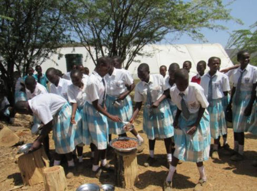 Students of Lake Bogoria Girls’ High school in Baringo South Sub-county take their meals outside under trees after the main dining was converted into a dormitory./JOSEPH KANGOGO