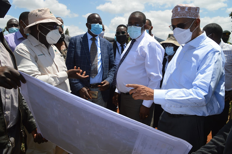 Senate Committee on National Security, Defence and Foreign Relations members Mohamed Mohamud, Mithika Linturi, Fred Outa and other officials being shown the map of 133 hectares Kiambu forest which is said to have been subdivided and sold to individuals without the land being degazetted